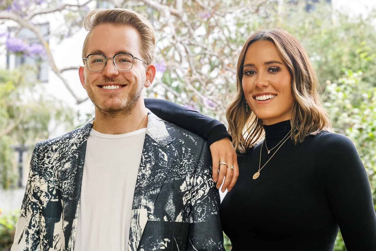 luxury hotel orli la jolla founder hailey and max waitt. Smiling siblings posing together outdoors, dressed in stylish modern outfits with greenery in the background.