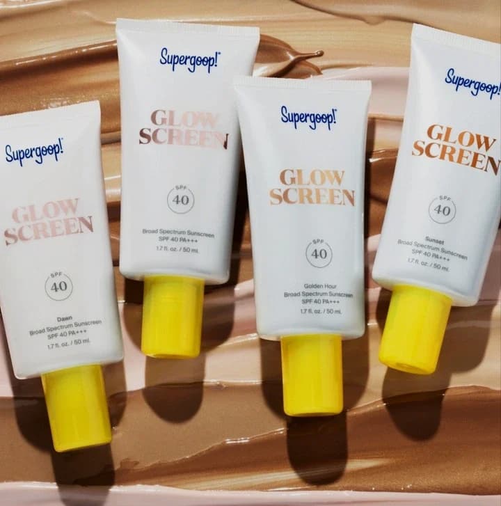 Supergoop! Glow Screen SPF 40 sunscreen tubes arranged on a sunlit surface for radiant skin protection