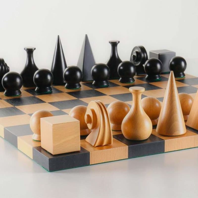 Modern wooden chess set with sculptural black and natural pieces arranged on a minimalist checkerboard, blending contemporary design and classic strategy.